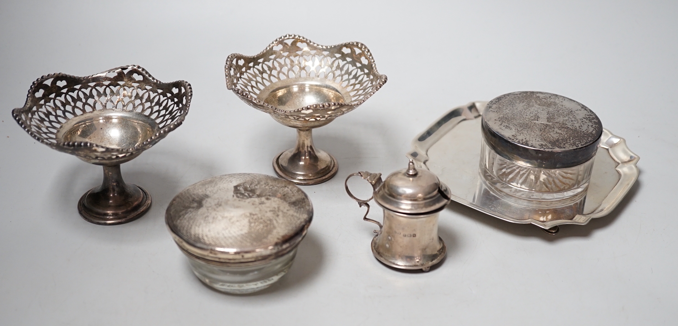 Sundry small silver including a late Victorian silver waiter, Birmingham, 1899, 14.5cm, two silver mounted toilet jars, a silver mustard pot and pair of silver pedestal tazzes.